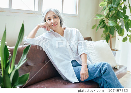 Senior woman relaxing on the sofa Senior woman relaxing on the sofa 107497883
