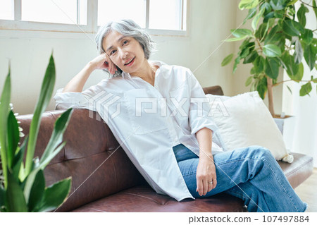 Senior woman relaxing on the sofa Senior woman relaxing on the sofa 107497884