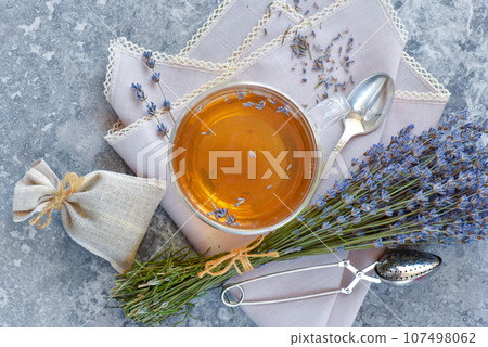 Bunch of lavender flowers, sachet filled with dried lavender and healthy tea. Top view. Flat lay. Bunch of lavender flowers, sachet filled with dried lavender and healthy tea. Top view. Flat lay. 107498062