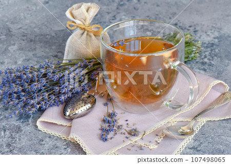 Fresh delicious tea with lavender and lavender flowers on gray stone table Fresh delicious tea with lavender and lavender flowers on gray stone table 107498065