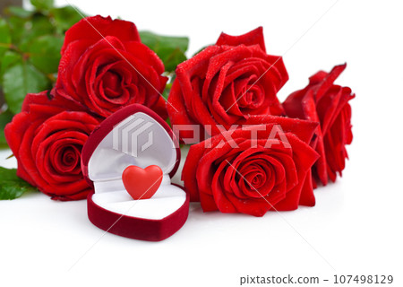 Red rose bouquet with open gift box with heart on a white background. Valentines Day concept. 107498129