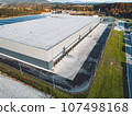 Aerial view of a side of large logistic distribution warehouse in Europe  107498168