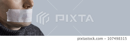 Man silenced with duct tape over his mouth. Photo with copy space. 107498315