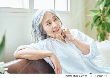 Senior woman relaxing on the sofa Senior woman relaxing on the sofa 107498534