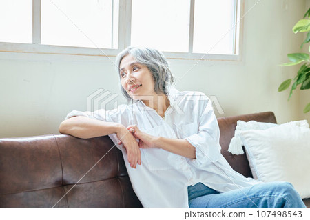 Senior woman relaxing on the sofa Senior woman relaxing on the sofa 107498543