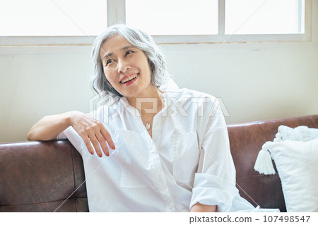 Senior woman relaxing on the sofa Senior woman relaxing on the sofa 107498547