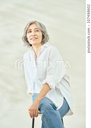 Senior woman sitting in a chair Senior woman sitting in a chair 107498602