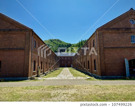 Landscape with red brick warehouse and blue sky 107499226
