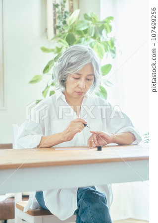 Senior woman doing nail care 107499256