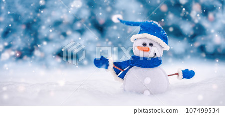 Little handmade snowman on the white snow on blue background. Little handmade snowman on the white snow on blue background. 107499534