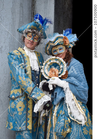 Couple of people dressed up for the Venice Carnival 107500900