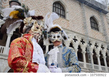 Couple of people dressed up for the Venice Carnival wearing cat masks Couple of people dressed up for the Venice Carnival wearing cat masks 107500922