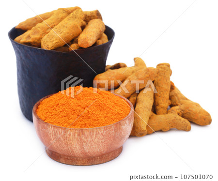 Whole and ground turmeric with mortar and pestle Whole and ground turmeric with mortar and pestle 107501070