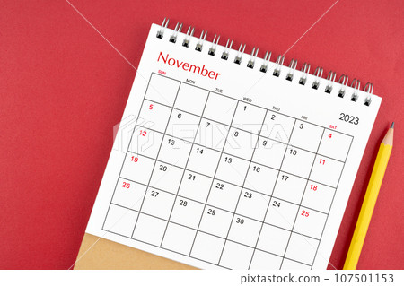 November 2023 desk calendar and pencil. 107501153