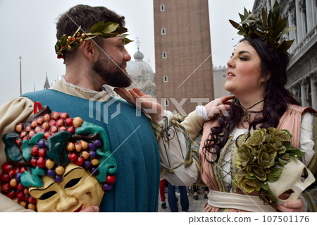 Couple of people dressed up for the Venice Carnival wearing Baco and Ariadna costumes 107501176