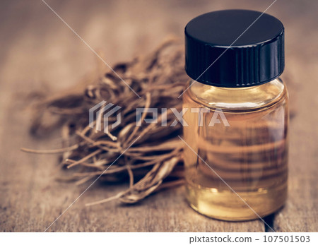Dry leaves of medicinal cannabis with extract oil in a bottle 107501503