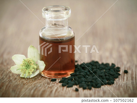 Nigella flower with seeds and essential oil Nigella flower with seeds and essential oil 107502162