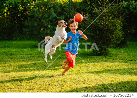 Family having fun outdoor with dog and basketball ball 107502234