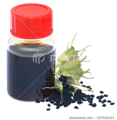 Nigella seeds and essential oil in a glass bottle 107502235