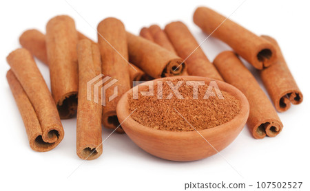 Bunch of some fresh aromatic cinnamon with powder spice 107502527