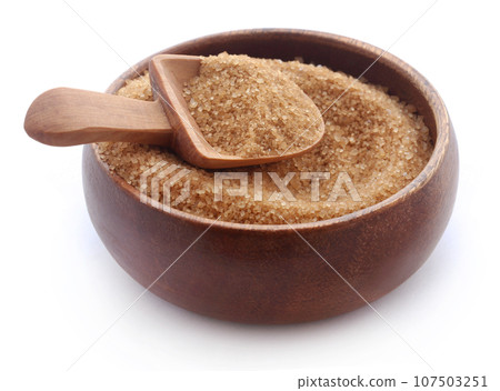 Brown sugar with wooden scoop Brown sugar with wooden scoop 107503251