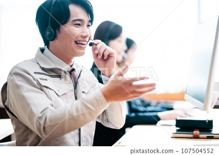 Young engineer working at a call center Young engineer working at a call center 107504552