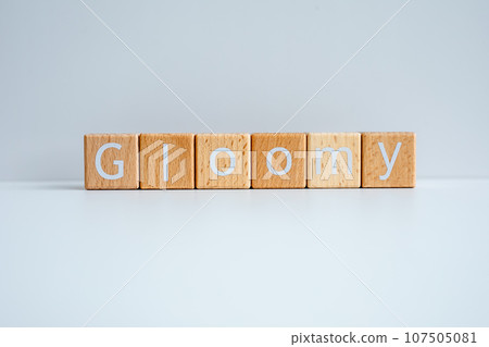 Wooden blocks form the text "Gloomy" against a white background. Wooden blocks form the text "Gloomy" against a white background. 107505081
