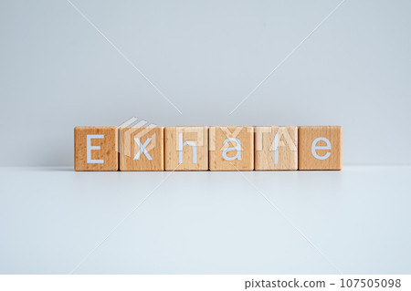 Wooden blocks form the text "Exhale" against a white background. Wooden blocks form the text "Exhale" against a white background. 107505098