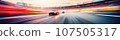 Under the night sky, a sleek sports car speeds along a racetrack. 107505317