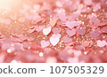 Celebratory confetti in harmonious pink and gold scatters across the frame. 107505329