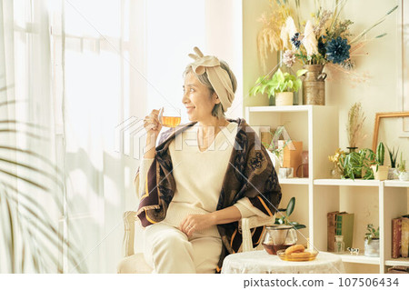 Senior woman having tea time 107506434
