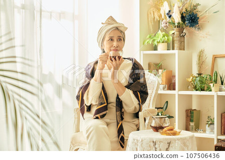 Senior woman having tea time 107506436