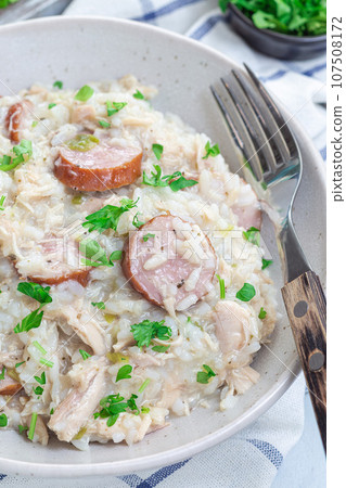South Carolina chicken bog dish with smocked sausages, in bowl, vertical, closeup 107508172