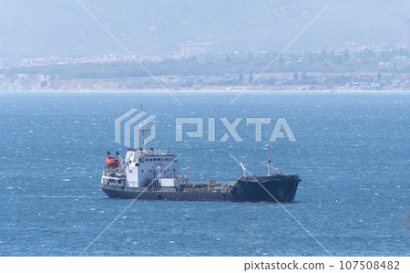 Large cargo ship in the Black Sea in the calm in Novorossiysk Large cargo ship in the Black Sea in the calm in Novorossiysk 107508482