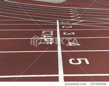 Red treadmill at the stadium with white lines 107508496