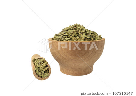 Dried leaves o Lemon verbena in latin Aloysia citrodora in wooden bowl and scoop isolated on white background. Medicinal herb. Dried leaves o Lemon verbena in latin Aloysia citrodora in wooden bowl and scoop isolated on white background. Medicinal herb. 107510147