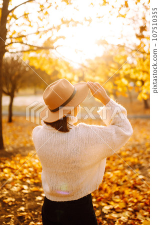 Young woman resting in nature. Fashion, style concept. People, lifestyle, relaxation and vacations. 107510355