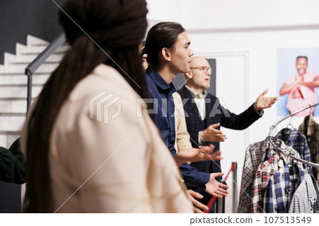 Diverse people customers arguing with clothing store staff while waiting in line for sales. Angry anxious crowd wait when Black Friday special offers start, standing at shopping mall entrance Diverse people customers arguing with clothing store staff while waiting in line for sales. Angry anxious crowd wait when Black Friday special offers start, standing at shopping mall entrance 107513549