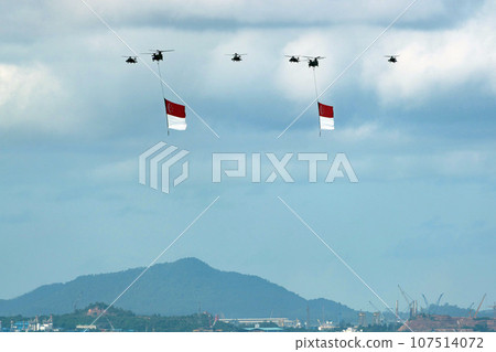 Military helicopter hoisting the national flag on Singapore Independence Day Military helicopter hoisting the national flag on Singapore Independence Day 107514072