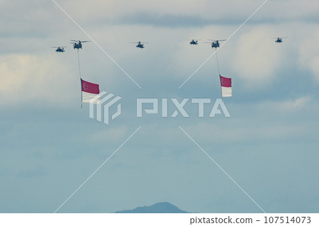 Military helicopter hoisting the national flag on Singapore Independence Day 107514073