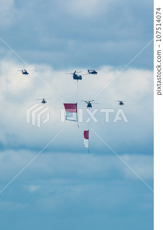 Military helicopter hoisting the national flag on Singapore Independence Day 107514074
