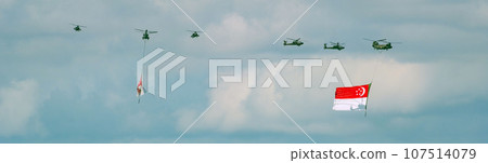 Military helicopter hoisting the national flag on Singapore Independence Day Military helicopter hoisting the national flag on Singapore Independence Day 107514079