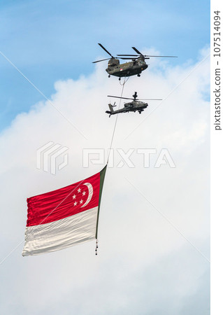 Military helicopter hoisting the national flag on Singapore Independence Day 107514094