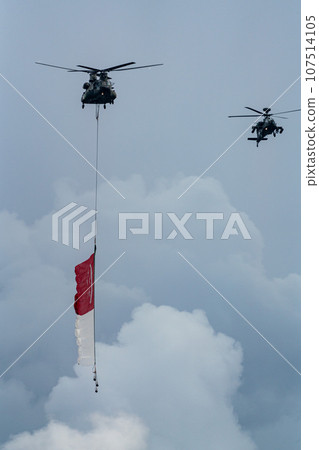 Military helicopter hoisting the national flag on Singapore Independence Day 107514105