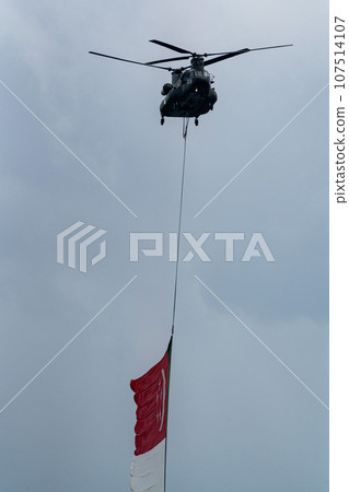 Military helicopter hoisting the national flag on Singapore Independence Day 107514107