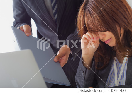 Young woman suffering from excessive stress at work 107514881