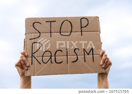 banner in hand stop racism against the sky 107515705