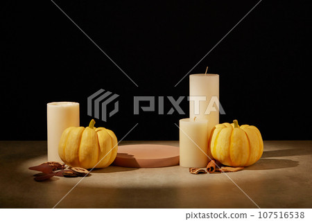 Empty podium in round shaped displayed with some candles and orange pumpkins. Concept scene stage showcase for new product and promotion sale Empty podium in round shaped displayed with some candles and orange pumpkins. Concept scene stage showcase for new product and promotion sale 107516538