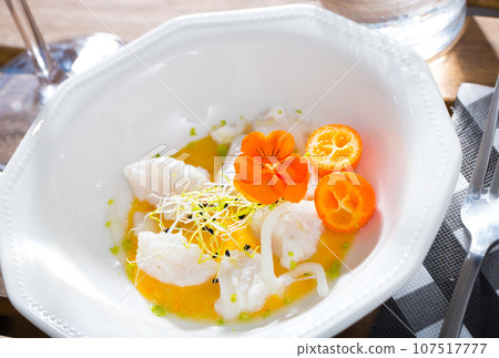 Ceviche from hake with spicy avocado sauce and cumquat at plate 107517777