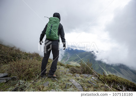 Hiking woman on high altitude mountain top 107518180